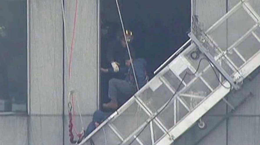 Firefighters save window washers trapped on broken scaffold