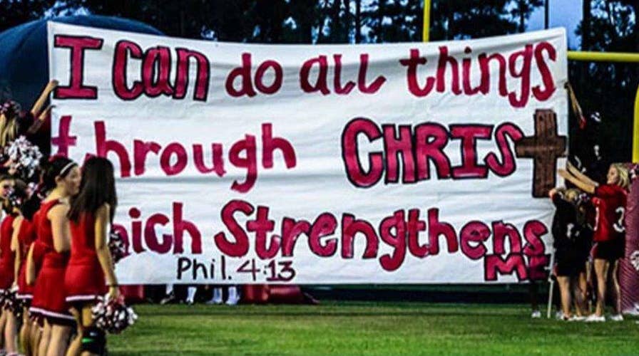 Texas court rules cheerleaders can display bible verses