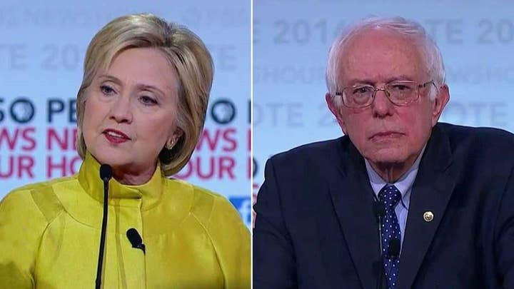 Sanders, Clinton clash over Wall St. campaign contributions