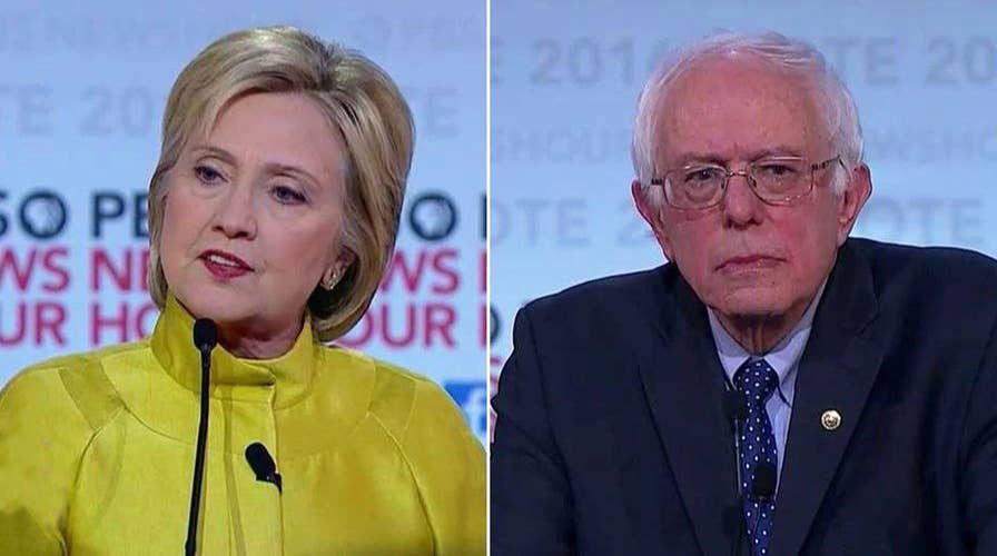 Sanders, Clinton clash over Wall St. campaign contributions