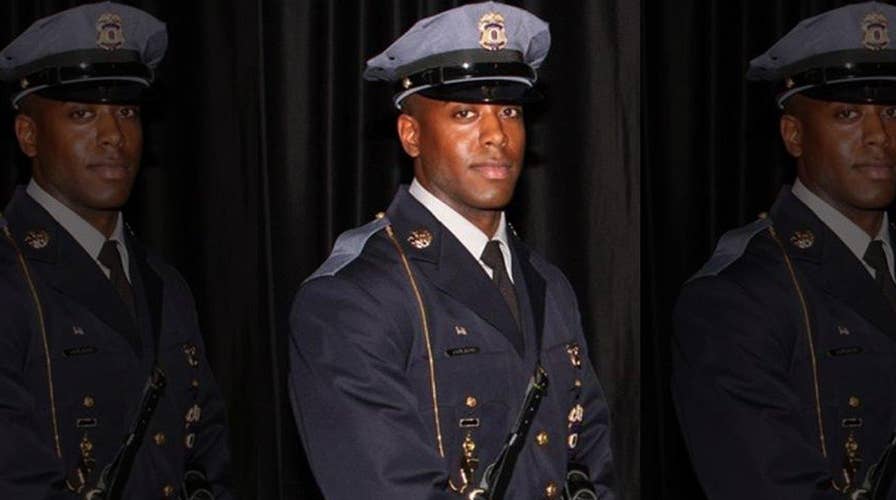 Officer gunned down outside of police headquarters 