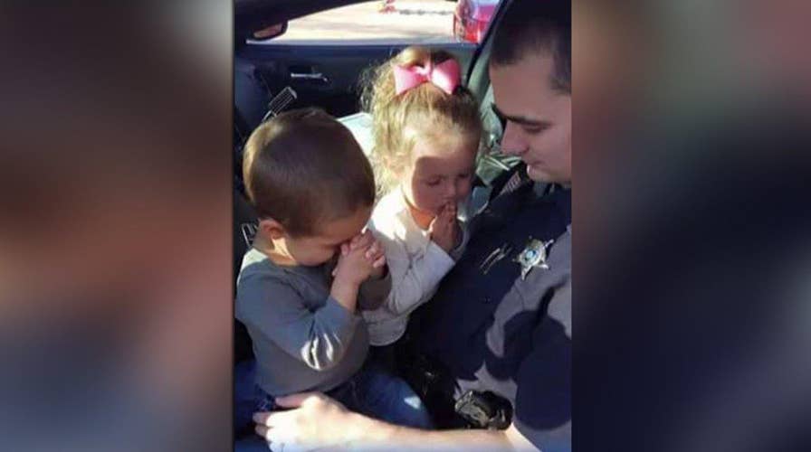 Photo of deputy praying with son and daughter goes viral