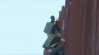 Mexican journalist records 2 suspected drug smugglers scaling border fence