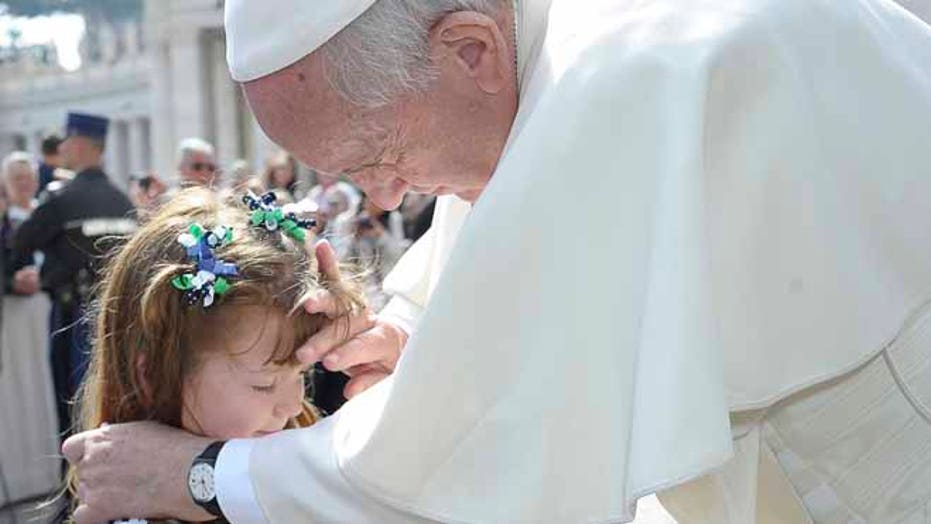 Pope Francis blesses eyes of 5-year-old girl