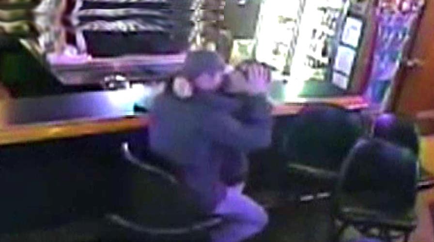 Kissing couple oblivious to robbery behind them