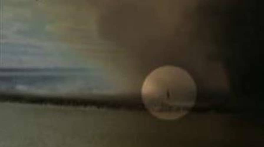 Firefighter dives into river to escape 'fire tornado'