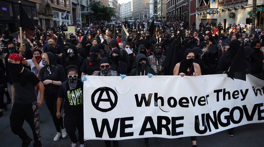 At least 9 arrested, 5 officers hurt in May Day clashes