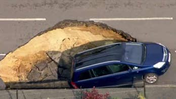 Giant sinkhole swallows car in London