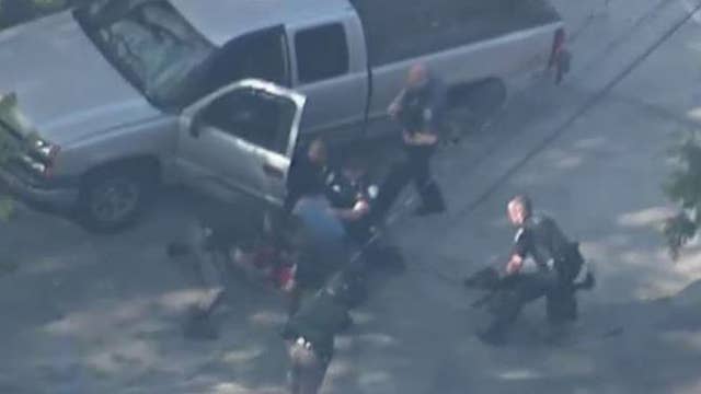 Video shows policemen beating suspect after car chase