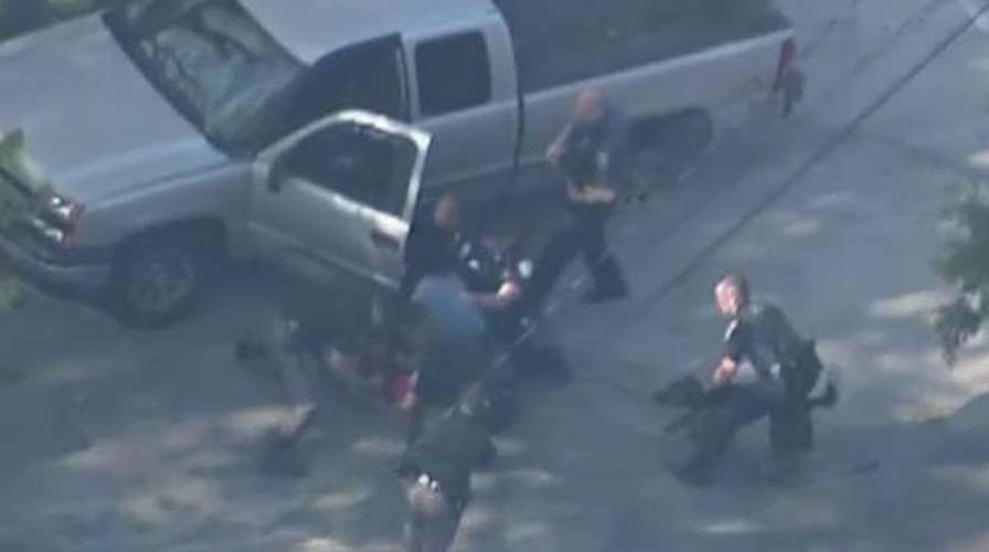 Video shows policemen beating suspect after car chase