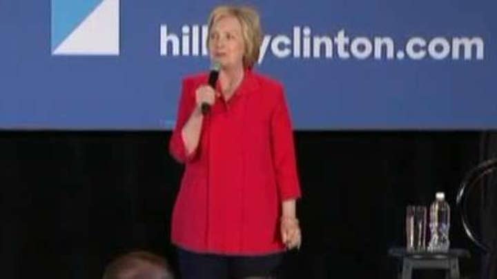 Clinton debuts new campaign slogan as 2016 race narrows
