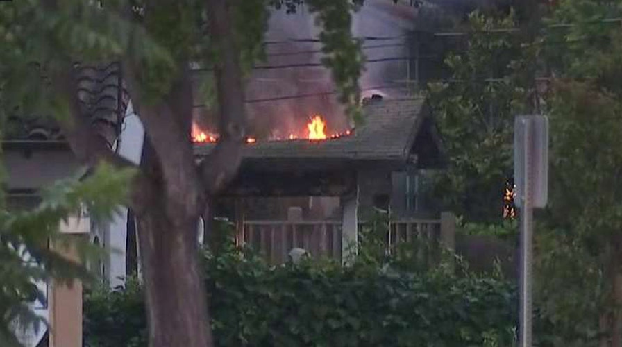 Suspected gunman barricaded inside burning building