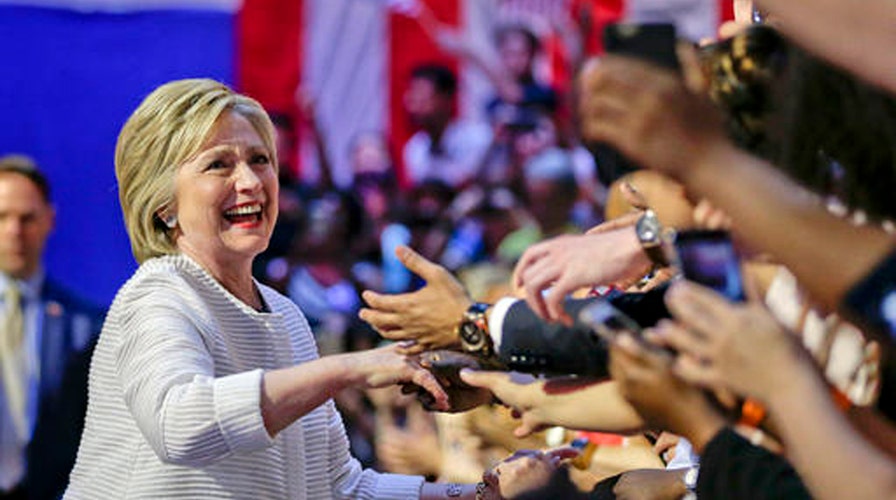 Clinton makes history amid calls for party unity