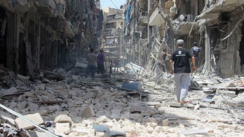 Dozens of US officials call for military action against Syria's Assad