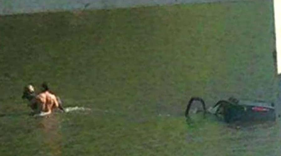 Man hailed hero after saving woman from SUV sinking in river