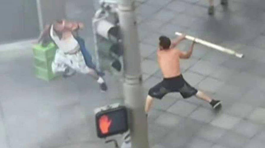 Shirtless man attacks bystanders with pole