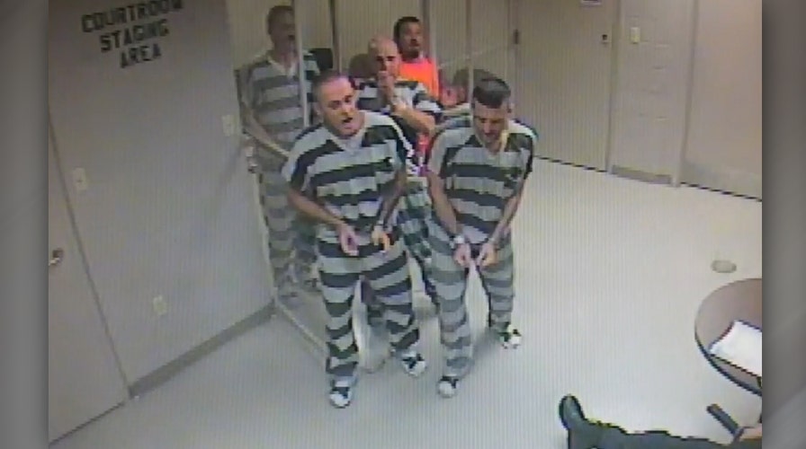 Inmates break free from holding cell to help officer