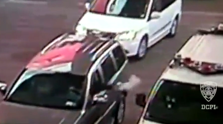 Video shows man toss fake bomb into police car