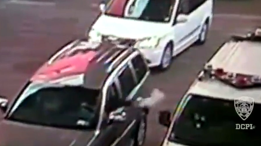 Video shows man toss fake bomb into police car