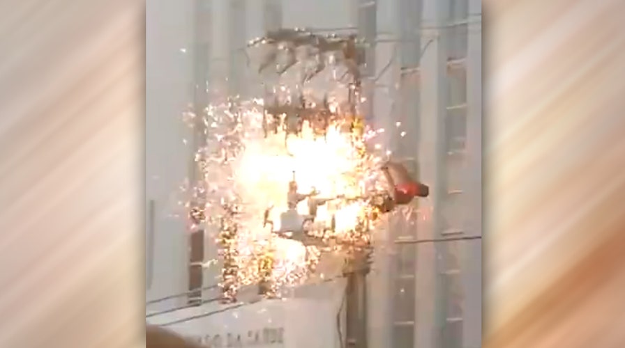 Warning, graphic video: Man electrocuted on utility pole