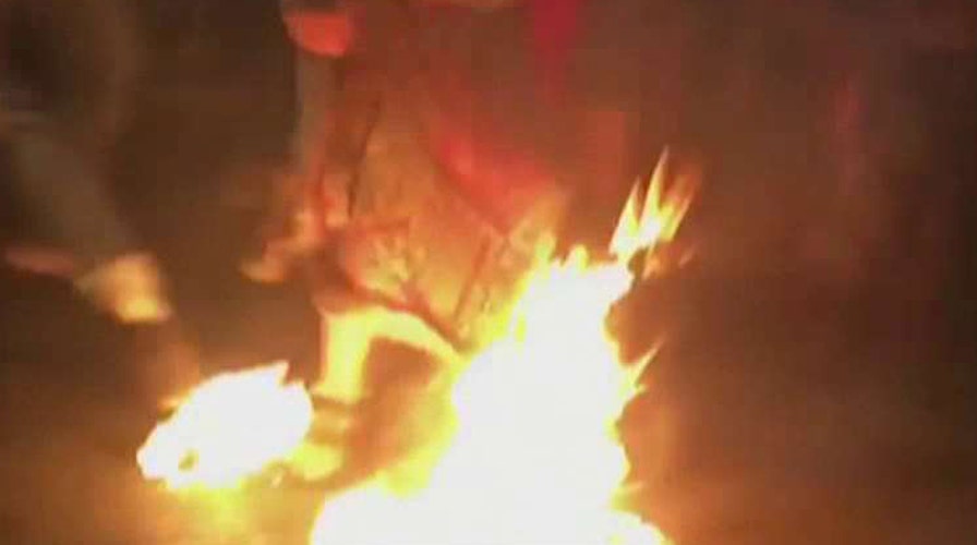 Protester outside DNC sets flag, then himself on fire