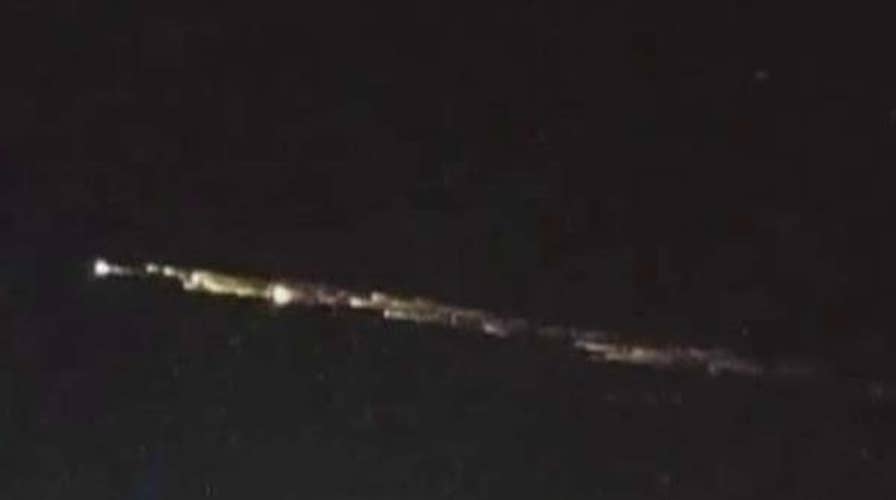 Fragments from a Chinese rocket streak across the night sky