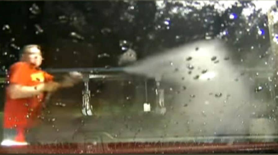 Driver thwarts armed carjacker with car wash power spray