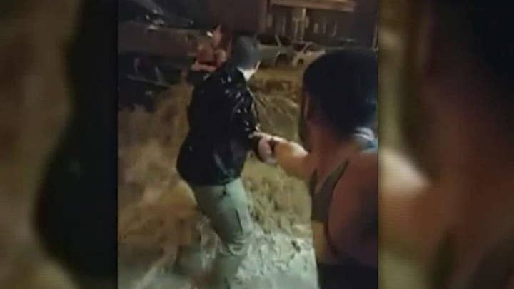 Human chain forms to save woman from rising flood waters