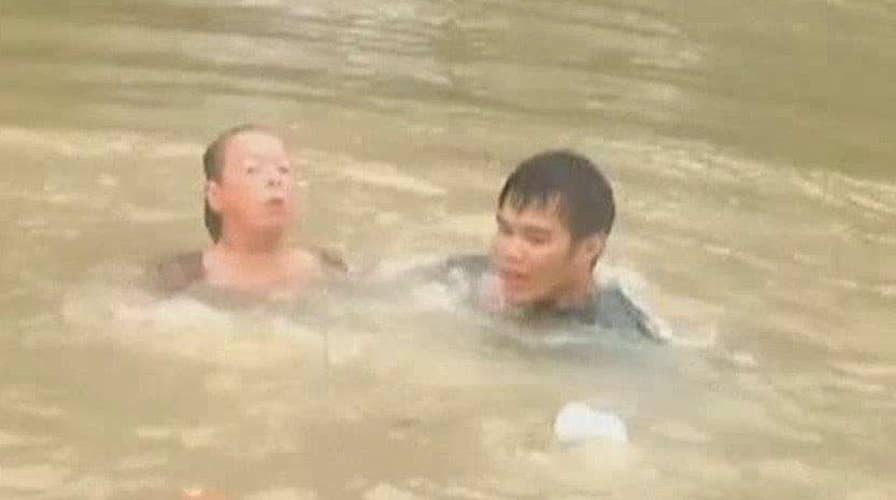 Woman, dog rescued from raging Louisiana floodwaters