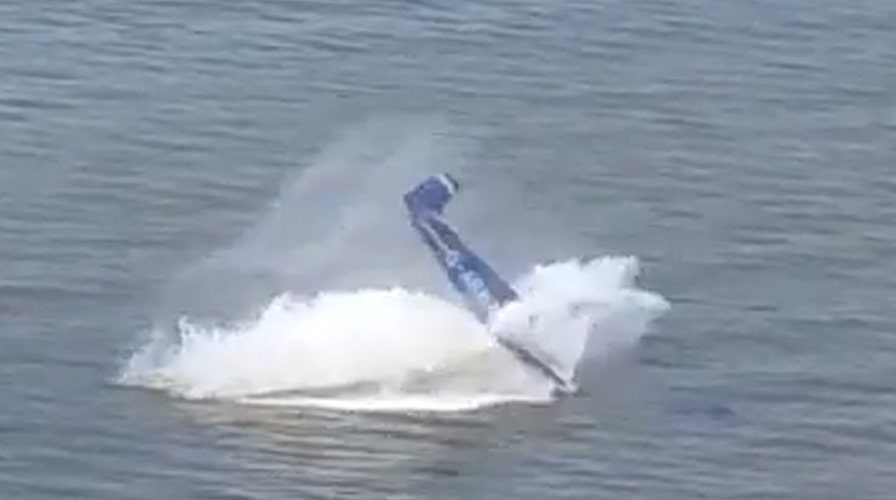 Plane flips after crashing into water during airshow