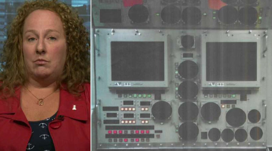 Mom of sailor charged over classified photo bashes Clinton