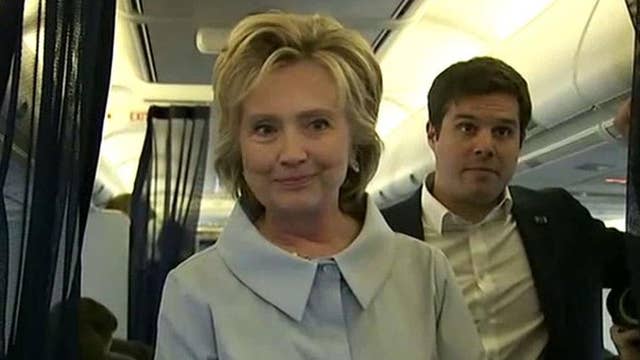 Clinton speaks to press in back of new campaign plane