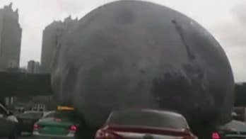 Caught on video: Inflatable 'moon' rolls over cars, scares drivers in storm