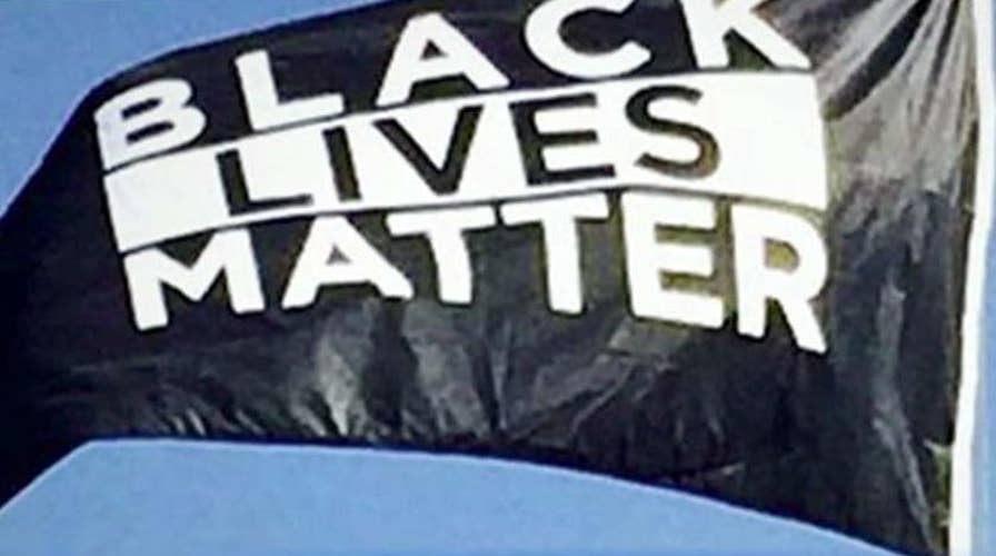 BLM flag hangs by US flag on college campus