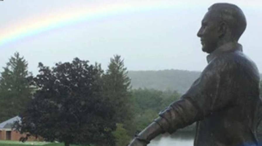 Rainbow appears over Arnold Palmer statue