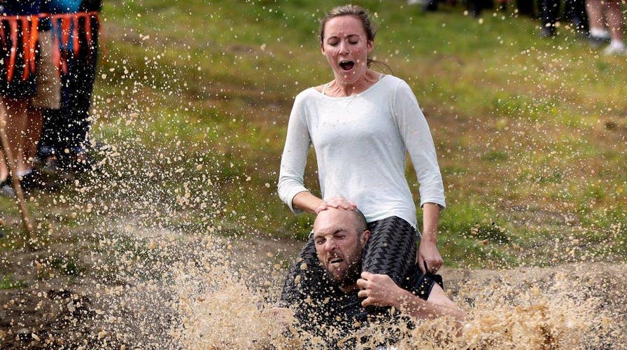 Couples compete for beer, cash in wife carrying contest