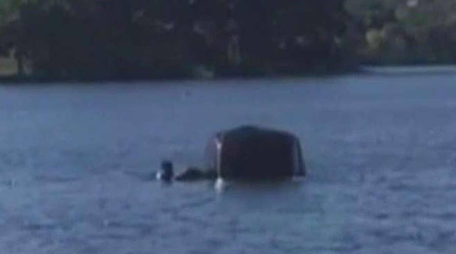 Bystanders rescue woman trapped in sinking SUV