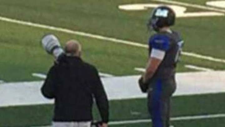 Lone football player stands for anthem while team protests