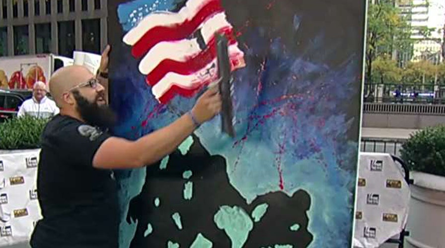 Artist paints mural while singing the national anthem