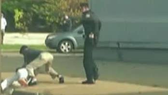 Caught on video: Officer wrestles man who speeds off in police cruiser