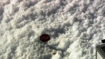 That's no snow: Sea of foam cascades from airport hangar