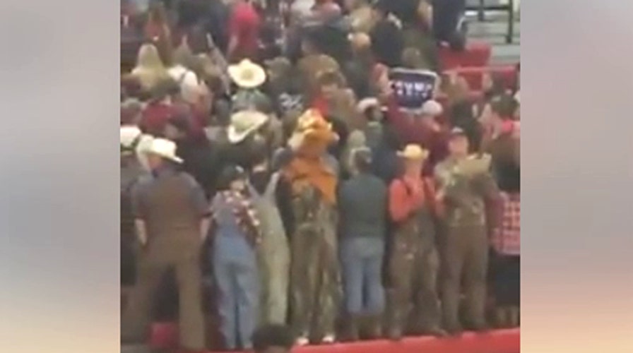 White students hold 'Trump' sign, turn backs on black team