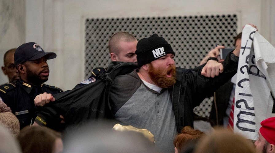 Protestors crash confirmation hearings for Trump's Cabinet