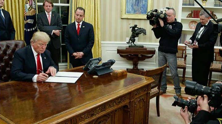 Trump signs order for agencies to ease burden of ObamaCare