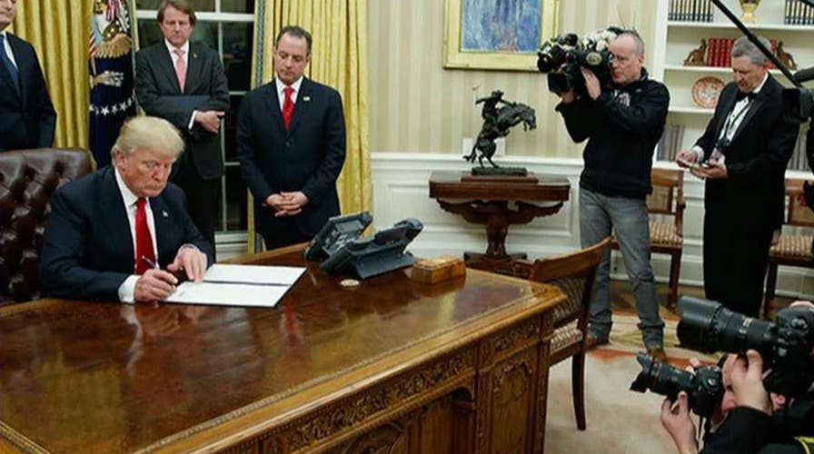 Trump signs order for agencies to ease burden of ObamaCare