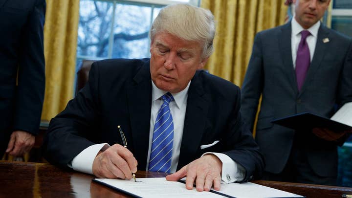 Trump signs executive order withdrawing US from TPP