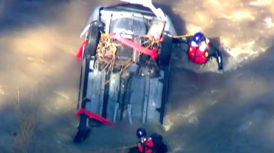 Teams work to recover submerged car, search for driver