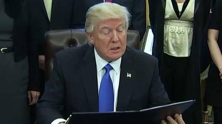 Trump signs orders on lobbying ban and plan to defeat ISIS