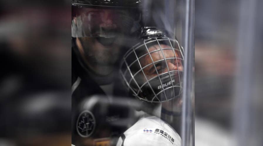 Justin Bieber gets hit, bounces back in celeb hockey game