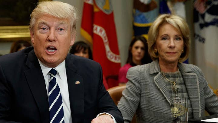 Trump praises DeVos for her 'toughness' and 'genius'